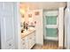Bright bathroom featuring a vanity with storage and a separate linen closet for added convenience at 25600 Se 152Nd Pl, Umatilla, FL 32784