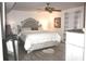 Comfortable bedroom with a full bed, neutral walls, wood flooring, and decorative lighting at 25600 Se 152Nd Pl, Umatilla, FL 32784