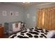 Cozy bedroom featuring a patterned bedspread and matching decor, perfect for relaxation and comfort at 25600 Se 152Nd Pl, Umatilla, FL 32784