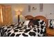 Comfortable bedroom featuring a uniquely patterned bedspread and matching decor accents at 25600 Se 152Nd Pl, Umatilla, FL 32784