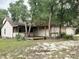 Charming single story home with a wooden deck and a large yard surrounded by mature trees at 25600 Se 152Nd Pl, Umatilla, FL 32784