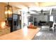 Open-concept kitchen and living room featuring modern lighting, stainless steel appliances, and neutral colored walls at 25600 Se 152Nd Pl, Umatilla, FL 32784