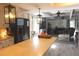 Open-concept kitchen and living room featuring modern lighting, stainless steel appliances, and neutral colored walls at 25600 Se 152Nd Pl, Umatilla, FL 32784