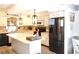 Bright kitchen with an island, stainless steel appliances, granite countertops, and pendant lighting at 25600 Se 152Nd Pl, Umatilla, FL 32784