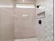 An elegant shower has chic mosaic accents and modern black fixtures at 5 Willow Trl, Ocala, FL 34472
