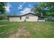 Expansive backyard featuring a well-maintained lawn and a screened-in patio area for outdoor enjoyment at 5018 Se 106Th Pl, Belleview, FL 34420