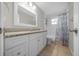 Updated bathroom features granite countertop, tile floors, and tub with subway tile surround at 5018 Se 106Th Pl, Belleview, FL 34420