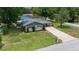 Aerial view of a cozy home with a carport, well-manicured lawn, and a serene neighborhood setting at 5018 Se 106Th Pl, Belleview, FL 34420