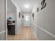 Hallway with tile flooring, neutral paint, and decorative wall hangings at 5018 Se 106Th Pl, Belleview, FL 34420