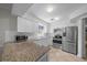 Modern kitchen with stainless steel appliances, granite countertops, and white cabinets at 5018 Se 106Th Pl, Belleview, FL 34420