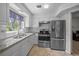Bright kitchen features granite countertops, white cabinets, stainless steel appliances and subway tile backsplash at 5018 Se 106Th Pl, Belleview, FL 34420
