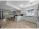 Bright and airy kitchen features updated appliances, white cabinetry, and an eat-in dining area at 5018 Se 106Th Pl, Belleview, FL 34420