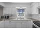 Bright kitchen features granite countertops, white cabinets, stainless steel appliances and subway tile backsplash at 5018 Se 106Th Pl, Belleview, FL 34420