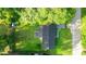 Aerial view of a home with lush green lawn and mature trees at 6021 Nw 54Th Ter, Ocala, FL 34482
