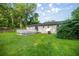 Spacious backyard featuring a well-maintained lawn and a white wooden deck, perfect for outdoor entertaining at 6021 Nw 54Th Ter, Ocala, FL 34482