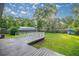 Overhead view of backyard featuring a white wooden deck and a large storage shed at 6021 Nw 54Th Ter, Ocala, FL 34482