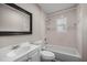 A clean bathroom featuring a shower over bath, large mirror, and vanity at 6021 Nw 54Th Ter, Ocala, FL 34482