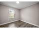A cozy bedroom with hardwood floors and a decorative window letting in natural light at 6021 Nw 54Th Ter, Ocala, FL 34482