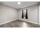 Bedroom featuring a window with dark curtains, neutral paint, and hard surface flooring at 6021 Nw 54Th Ter, Ocala, FL 34482