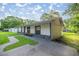 Side view of a charming home with a stone base and updated walkway at 6021 Nw 54Th Ter, Ocala, FL 34482