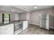 Modern kitchen with stainless steel appliances and granite countertops overlooking a cozy dining area at 6021 Nw 54Th Ter, Ocala, FL 34482