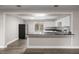 Bright kitchen with stainless steel refrigerator, granite countertops and white cabinets, and a view to the backyard at 6021 Nw 54Th Ter, Ocala, FL 34482