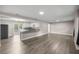 Open concept living room flows into the kitchen and features hard surface floors and neutral paint at 6021 Nw 54Th Ter, Ocala, FL 34482