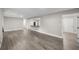 Open living area with views of the kitchen, hard surface floors, and neutral paint at 6021 Nw 54Th Ter, Ocala, FL 34482