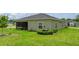 Lush backyard featuring a screened-in porch, mature landscaping, and a well-maintained lawn at 7828 Sw 74Th Loop, Ocala, FL 34481