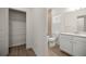 Bathroom with a tile floor, a toilet, a vanity, and a closet with wire shelving at 7828 Sw 74Th Loop, Ocala, FL 34481