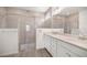 Modern bathroom with double vanity, frameless glass shower, and neutral tile at 7828 Sw 74Th Loop, Ocala, FL 34481