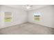 Bright, carpeted bedroom featuring two windows for plenty of natural light at 7828 Sw 74Th Loop, Ocala, FL 34481