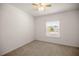 Cozy bedroom with neutral carpet, ceiling fan, and window providing natural light at 7828 Sw 74Th Loop, Ocala, FL 34481