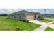View of the house with green lawn and driveway, highlighting a well-kept exterior at 7828 Sw 74Th Loop, Ocala, FL 34481