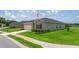 Well-maintained single-story home with green grass, and a neatly paved driveway at 7828 Sw 74Th Loop, Ocala, FL 34481