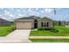 Charming single-story home featuring a two-car garage, well-manicured lawn, and an American flag at 7828 Sw 74Th Loop, Ocala, FL 34481