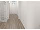 Hallway with tile flooring and white walls leading to the front door with a transom window at 7828 Sw 74Th Loop, Ocala, FL 34481