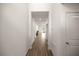 Hallway featuring white walls, recessed lighting, and stylish tile flooring leading to the dining area at 7828 Sw 74Th Loop, Ocala, FL 34481