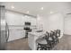 Bright kitchen featuring a large island with seating, stainless steel appliances, and white cabinetry at 7828 Sw 74Th Loop, Ocala, FL 34481