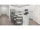 Bright kitchen featuring a large island with seating, stainless steel appliances, and white cabinetry at 7828 Sw 74Th Loop, Ocala, FL 34481