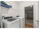 A laundry room with a washer, dryer, and wire rack for storage at 7828 Sw 74Th Loop, Ocala, FL 34481