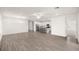 Open-concept living space with kitchen island, stainless appliances, and wood-look tile floors at 7828 Sw 74Th Loop, Ocala, FL 34481