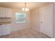 Cozy eat-in kitchen with white cabinetry and tile flooring, bathed in natural light at 956 Osceola Trl, Casselberry, FL 32707