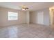 Open living room with tile flooring, neutral walls, and a ceiling fan at 956 Osceola Trl, Casselberry, FL 32707