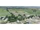 Aerial view showcasing a sprawling land parcel with a mix of open fields and a couple of buildings at 4880 Bannon Island Rd, Haines City, FL 33844