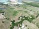 Aerial view showcasing the property's spacious grounds with a combination of trees, open spaces and ponds at 4880 Bannon Island Rd, Haines City, FL 33844