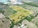 Stunning aerial shot of extensive property, featuring a combination of green pastures, ponds, and mature trees within the boundaries at 4880 Bannon Island Rd, Haines City, FL 33844