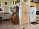 Traditional kitchen featuring tile floors, wooden cabinets, and white refrigerator at 4880 Bannon Island Rd, Haines City, FL 33844