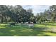 Image showcasing cattle grazing within a serene pasture, set against a backdrop of mature trees at 4880 Bannon Island Rd, Haines City, FL 33844