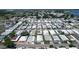 Aerial view of a vibrant mobile home community near a body of water, highlighting its organized layout at 6739 Kensington Ne Dr, Winter Haven, FL 33881